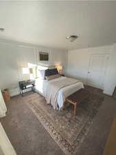 Bedroom featuring carpet and a textured ceiling