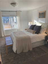 Carpeted bedroom with a textured ceiling