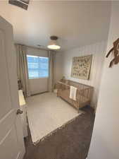 Bedroom featuring carpet and wooden walls