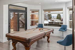 Rec room featuring hardwood / wood-style flooring, pool table, and a healthy amount of sunlight