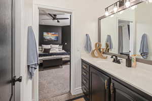 Bathroom featuring vanity, tile patterned flooring, and ceiling fan