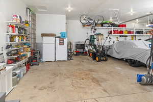 Garage featuring white refrigerator