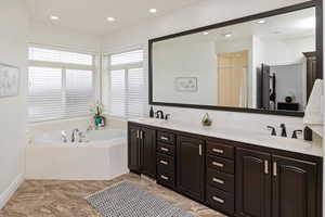 Bathroom featuring vanity and plus walk in shower