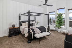 Carpeted bedroom featuring ceiling fan and multiple windows