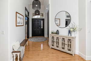 Foyer featuring crown molding and light hardwood / wood-style flooring