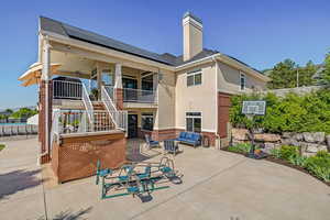 Rear view of house with a patio area and solar panels