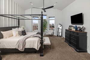 Carpeted bedroom with ceiling fan and lofted ceiling