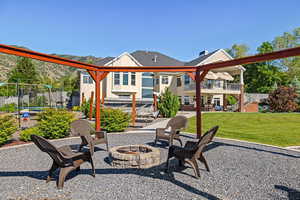 View of patio / terrace with a fire pit and a trampoline