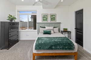 Bedroom with dark carpet and ceiling fan