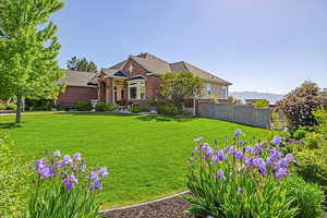 View of front facade featuring a mountain view and a front lawn