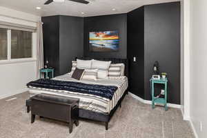 Carpeted bedroom with a textured ceiling and ceiling fan