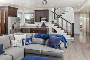 Living room featuring wood-type flooring, sink, and a wealth of natural light