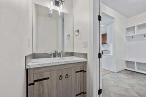 Bathroom with tile patterned flooring and vanity