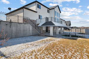 Rear view of house with a trampoline and a patio