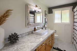 Bathroom featuring vanity and toilet