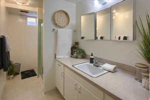 Bathroom featuring vanity and a shower