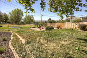 View of yard featuring a patio and a trampoline