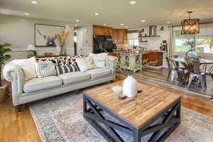 Living room featuring a notable chandelier and light hardwood / wood-style flooring