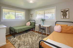 Bedroom with light hardwood / wood-style floors