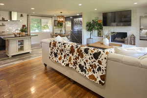 Living room with hardwood / wood-style flooring and a fireplace