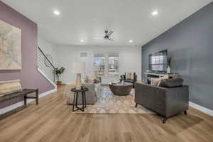 Living room featuring ceiling fan and light wood-type flooring