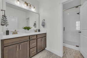 Bathroom featuring vanity and tiled shower