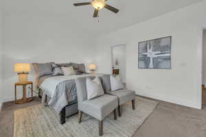 Bedroom with ceiling fan, lofted ceiling, and carpet flooring