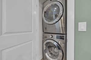 Washroom featuring stacked washer and dryer