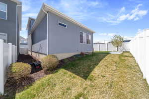 Exterior space featuring a fenced backyard and a lawn