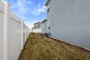 View of side of property with a lawn