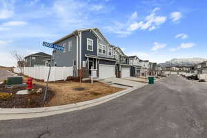 View of front of property with a garage and a mountain view