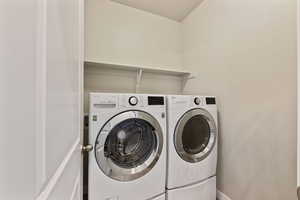 Clothes washing area featuring washing machine and dryer