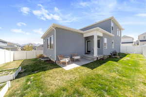Back of house with central AC, a yard, a fenced backyard, stucco siding, and a patio