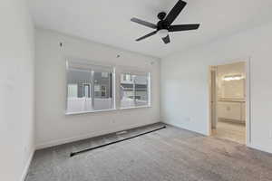 Unfurnished room featuring ceiling fan and light colored carpet