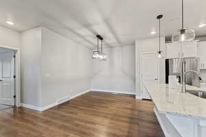 Dining room featuring sink and dark hardwood / wood-style floors