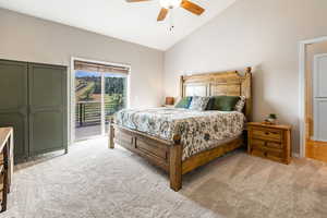 Primary Bedroom with lofted ceiling, access to exterior, and ceiling fan