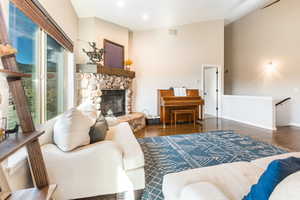 Living room with dark hardwood  floors and a fireplace