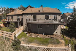 Rear view of property featuring central AC and a balcony