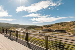 Wooden terrace featuring a mountain view