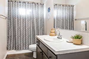 Bathroom featuring vanity, backsplash, and tub