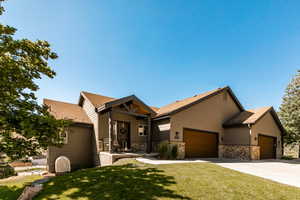 View of front of home featuring a garage and a front yard