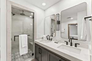 Bathroom with vanity and a shower with shower door