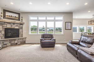 Living room with wood-type flooring, a wealth of natural light, and a fireplace