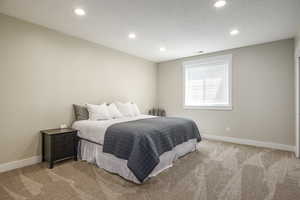 Carpeted bedroom with a textured ceiling