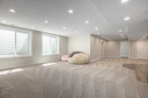 Interior space featuring light carpet and a textured ceiling