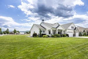 View of front of property featuring a garage and a front yard