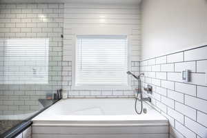 Bathroom featuring tiled tub