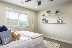 Bedroom with ceiling fan and carpet