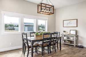 Dining room featuring a notable chandelier and hardwood / wood-style flooring