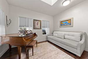 Interior space with lofted ceiling and dark hardwood / wood-style floors